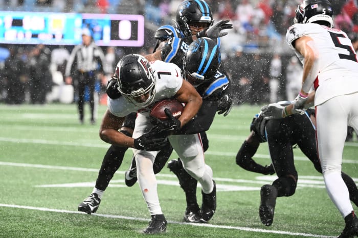 Atlanta Falcons running back Bijan Robinson (7) is tackled by Carolina Panthers safety Jeremy Chinn (21) in the second quarter at Bank of America Stadium.